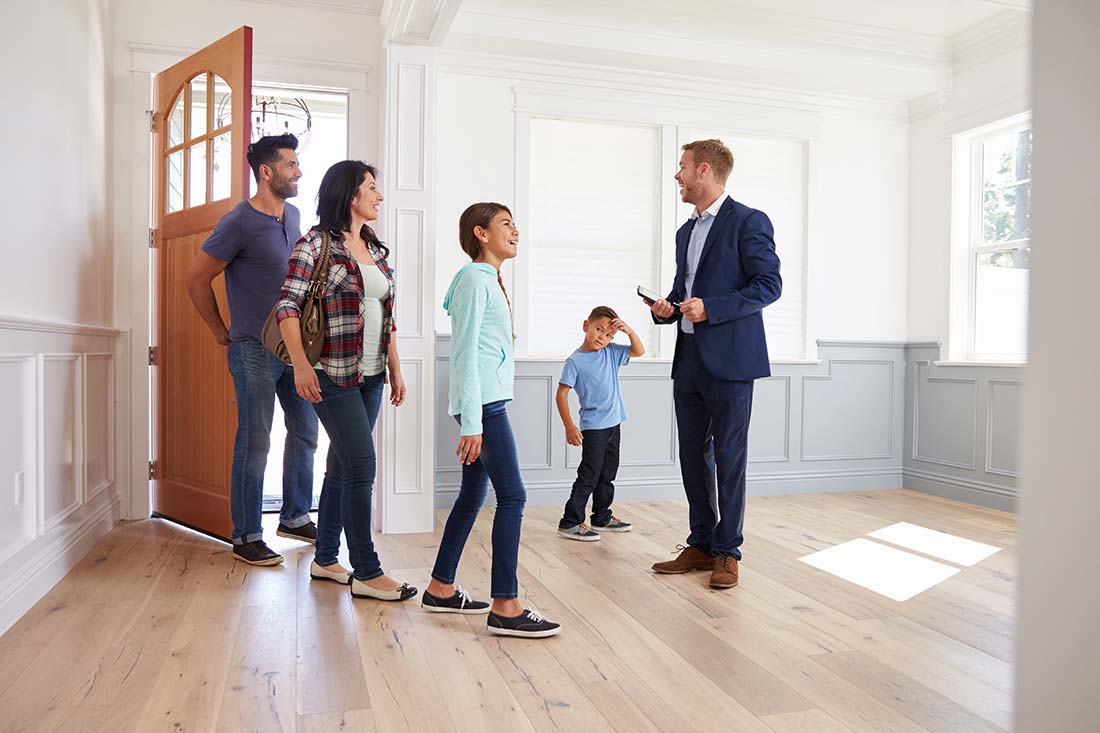 Realtor Showing a Family Around New Home after a thorough inspection by home inspector